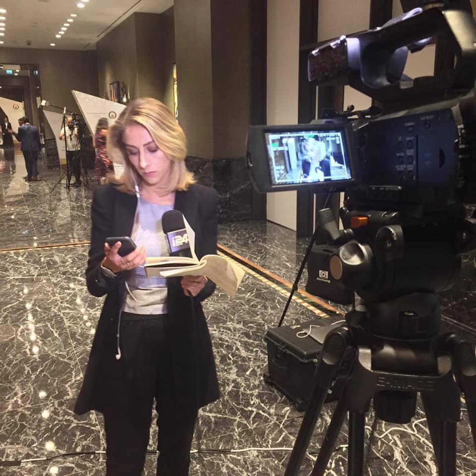 Nurit Ben preparing a report behind the scenes